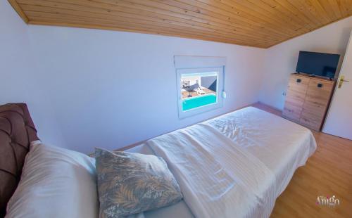 a living room with a bed and a window at Villa Pearl- with private pool in Blagaj