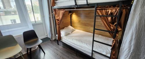 a bunk bed in a room with a window at Old City Guesthouse and Tour Ulaanbaatar Hostel in Ulaanbaatar