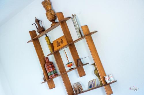 a wooden shelf on a wall with various items on it at Villa Pearl- with private pool in Blagaj