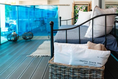 Una canasta con almohadas y una cama en una habitación. en BOSZKOWO Apartament "EDEL" 106 Aquarius, en Boszkowo-Letnisko