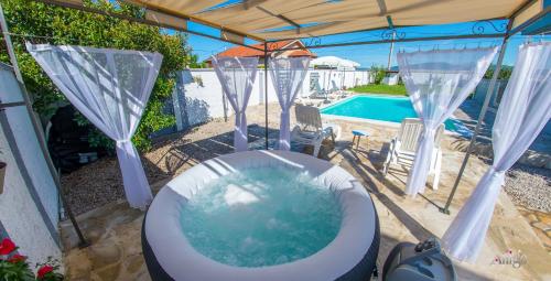 a toilet in a yard with a swimming pool at Villa Pearl- with private pool in Blagaj