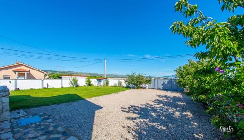 a driveway in a yard with a fence at Villa Pearl- with private pool in Blagaj