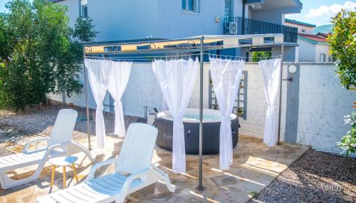 a gazebo with chairs and a hot tub at Villa Pearl- with private pool in Blagaj