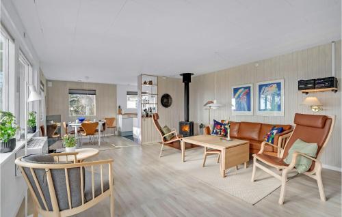 a living room with a couch and chairs and a table at Lovely Home In Nakskov in Nakskov