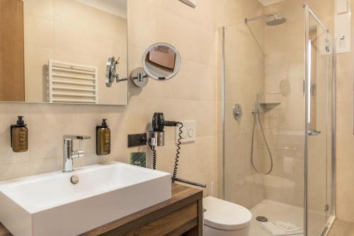 a bathroom with a sink and a shower at Schartneralm Kiefer Family in Collalbo