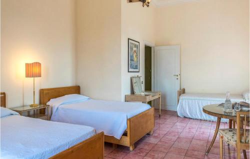 a hotel room with two beds and a table and a table sidx sidx at 5 Bedroom Amazing Home In Grottaferrata in Grottaferrata