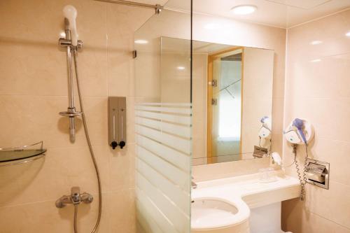 a bathroom with a shower and a toilet and a sink at Jeju Robero in Jeju
