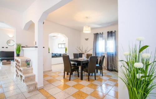 a dining room and living room with a table and chairs at Beautiful Home In Brodarica With Wifi in Brodarica