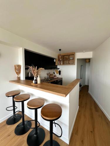 - une cuisine avec deux tabourets et un comptoir dans l'établissement L Horizon, Rennes centre, à Rennes