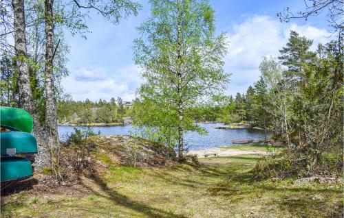 a view of a lake through the trees at Beautiful Home In Søndeled in Søndeled