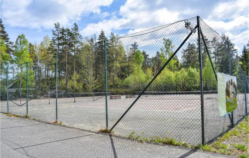 a tennis court with two tennis nets at Beautiful Home In Søndeled in Søndeled
