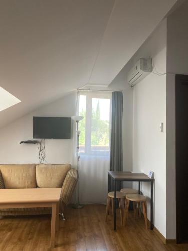 a living room with a couch and a table at Hotel Cité in Mtskheta