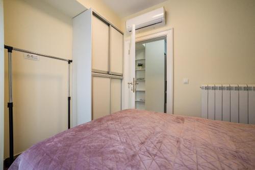 a bedroom with a bed and a closet at Villa Linz in Tivat