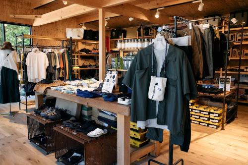 a clothing store with clothes and shoes on racks at Tiny Garden Tateshina in Chino