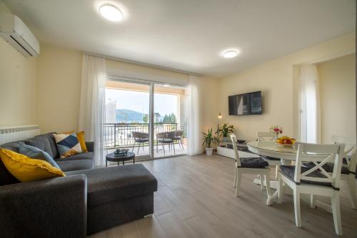 a living room with a couch and a table at Villa Linz in Tivat