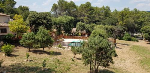 an aerial view of a yard with a pool and trees at Le Mas des Bois in Le Muy