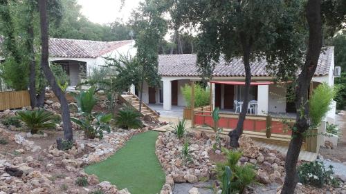a house with a garden in front of it at Le Mas des Bois in Le Muy