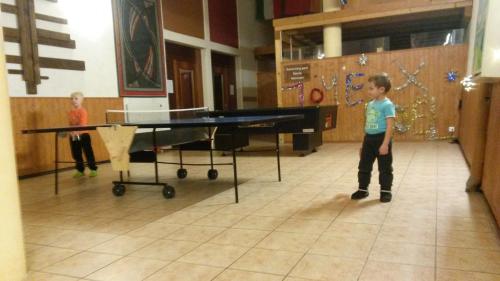 two young boys playing a game of ping pong at Résidence "Les Crêtes" in Torgon