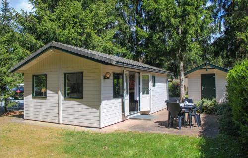 a small house with a table in a yard at Gorgeous Home In Vorden With Kitchen in Vorden