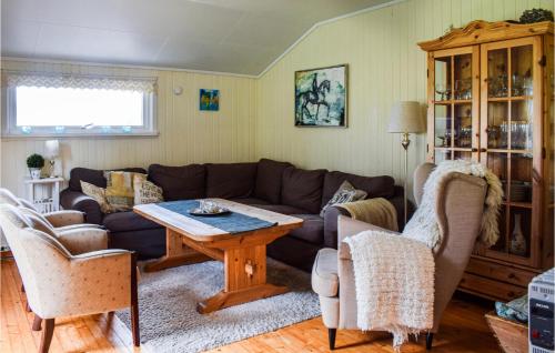 a living room with a couch and a table at Lovely Home In Enebakk With Wifi in Omberg