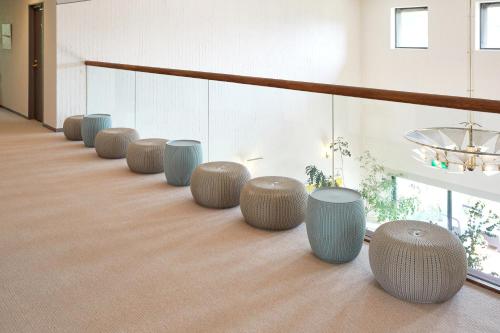a row of stools sitting on the floor of a room at IKOI Villa in Karuizawa