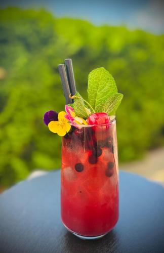 a drink sitting on a table with flowers in it at Grand Royal Hotel in Poznań