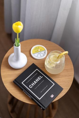 a small wooden table with a book on it at Lemoni House in Petras, Sitia, by Comfortbnb in Sitia
