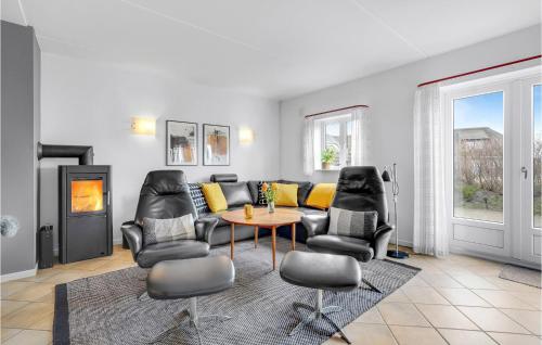 a living room with a couch and chairs and a table at Holiday Home Horns Bjerge Vi in Blåvand