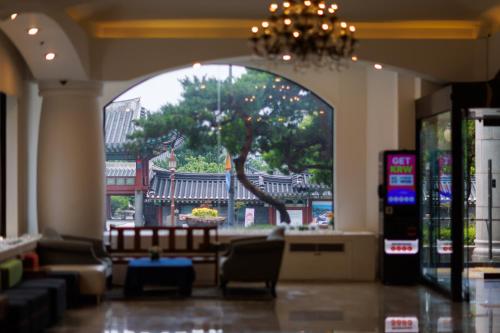 a lobby with a tree in the middle of a building at Jeju Robero in Jeju