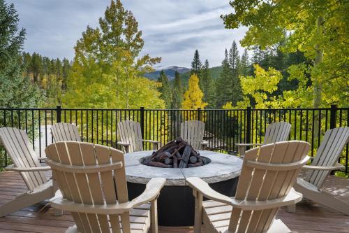 a table with chairs and a fire pit on a deck at Iron Horse C4093 condo in Winter Park