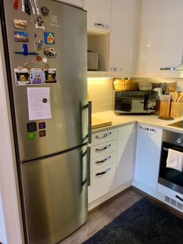 a kitchen with a stainless steel refrigerator at 2room Kalasatama Helsinki in Helsinki