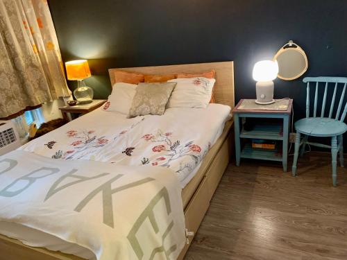 a bedroom with a bed and a table with a lamp at 2room Kalasatama Helsinki in Helsinki