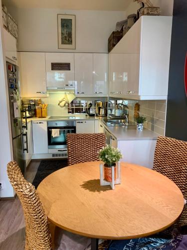 a kitchen with a wooden table and chairs at 2room Kalasatama Helsinki in Helsinki