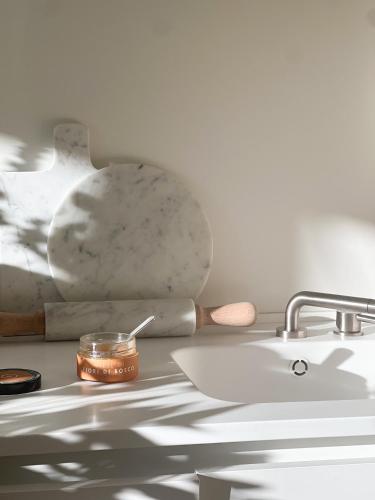 a kitchen counter with a sink and a bowl at CinziaHome Boutique B&B Spiaggia Privata in Lido di Fermo