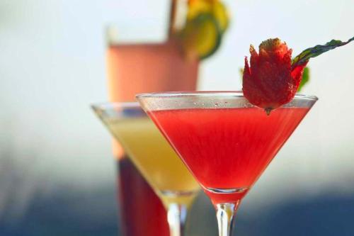 two cocktails sitting on top of a table at Celosia 1 BR Superior Room AN23 in Mangsit