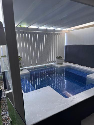 a swimming pool in the middle of a backyard at Beachside 3 with Private heated plunge pool in Port Douglas