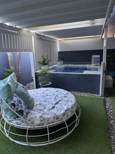 a room with a bed and a bath tub at Beachside 3 with Private heated plunge pool in Port Douglas