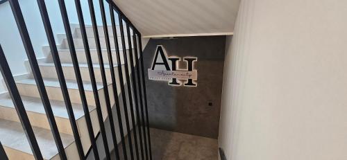 a staircase in a building with a sign on the wall at Arkady House in Olsztynek