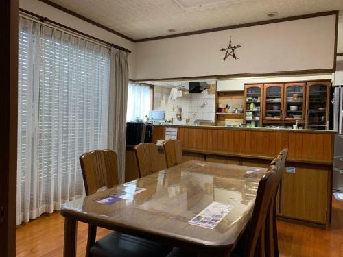 a dining room with a table and chairs at 民泊大森主屋 in Futami