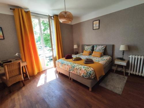 a bedroom with a bed and a large window at Toul superbe appartement plein centre in Toul