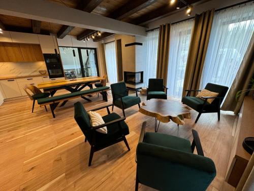 a large living room with a table and chairs at Chata pod Cigerníkom in Matiašovce
