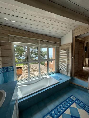 La grande salle de bains est pourvue d'une baignoire et d'une fenêtre. dans l'établissement L'équinoxe vue sur la mer, à Sète