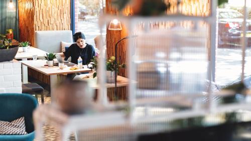a man sitting at a table in a restaurant at room2 Southampton Hometel in Southampton
