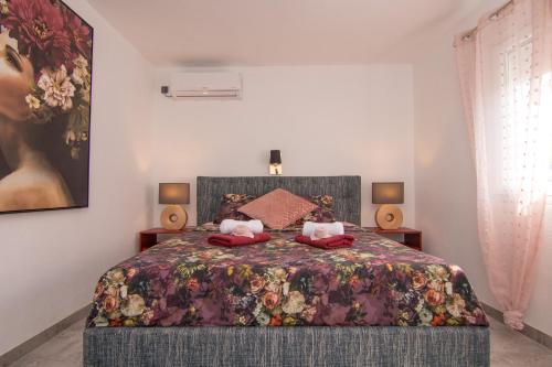 a bedroom with a bed with two teddy bears on it at Apartments Flowers - Heated Pool Near Beach in Krk
