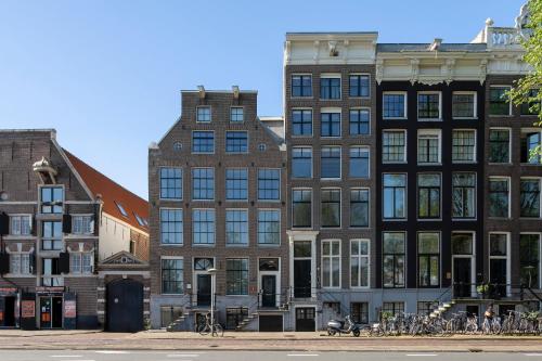 a group of buildings on a city street with bikes at Amsterdam Centre Harbour Apartments in Amsterdam