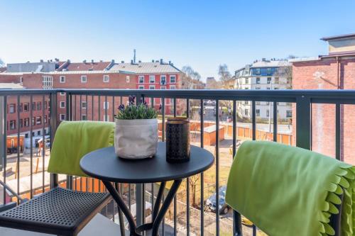 a table and chairs on a balcony with a view at The Apartments Company - Majorstuen in Oslo