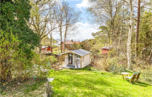 a small house in the middle of a yard at 1 Bedroom Awesome Home In Frillesås in Frillesås