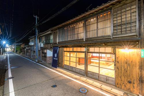 a building on a city street at night at NIPPONIA Sado 佐渡相川 金山町 in Sado