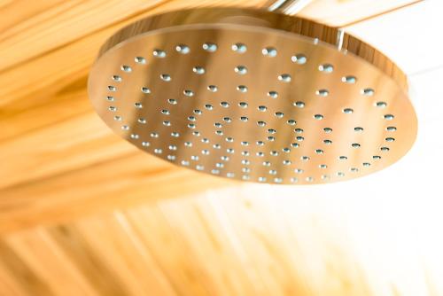 a light fixture hanging from a wooden ceiling at NIPPONIA Sado 佐渡相川 金山町 in Sado