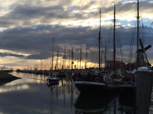 a group of boats docked in a marina with a cloudy sky at Zierikzee Appartement ZZ 41 at the Waterfront in Zierikzee